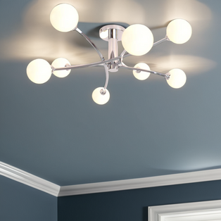 A contemporary ceiling light with a polished chrome finish, featuring curved arms and matt opal glass spheres.